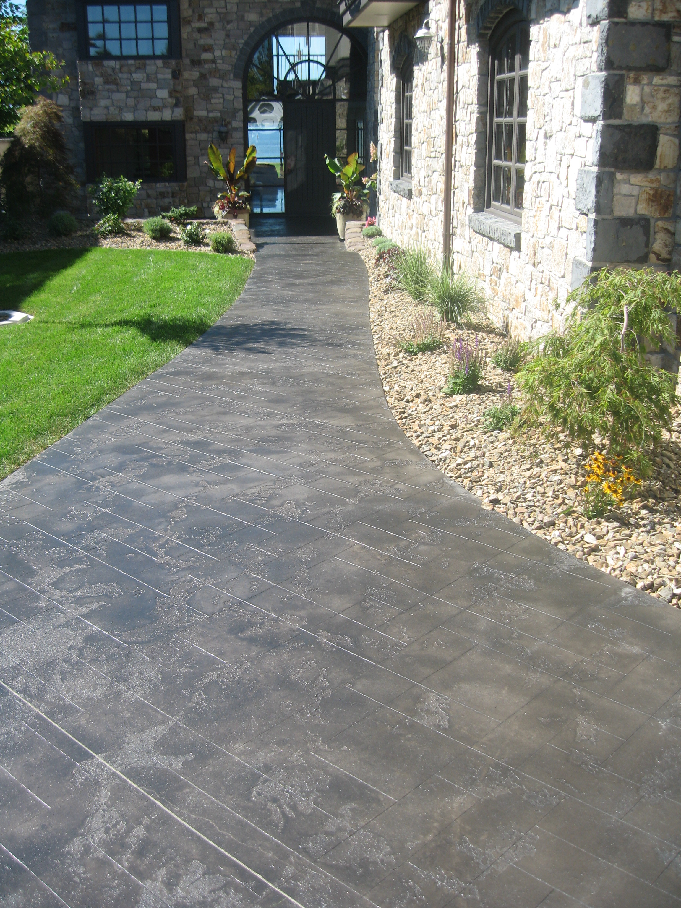 Thin-finish ultra-stone overlay walkway with antique stain
