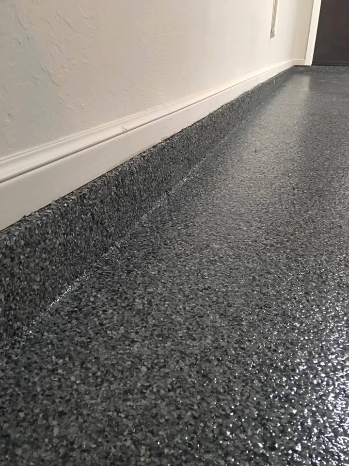 Gray flake broadcast floor with matching cove base detail