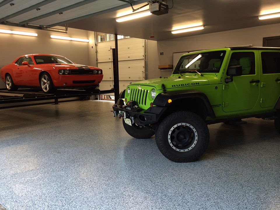 Blue-gray flake broadcast garage floor with sports cars