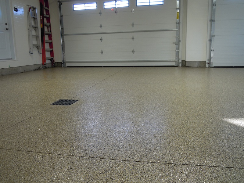 Tan flake broadcast garage floor with floor drain